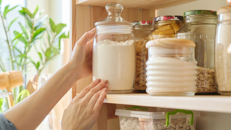 woman's hand reaching into a small pantry