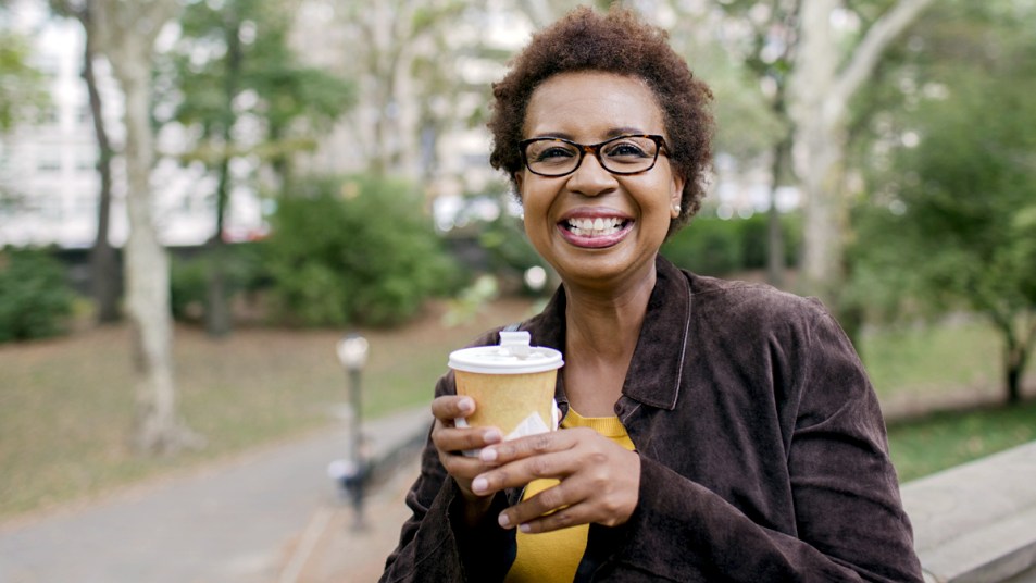 Woman holding a to-go cup of coffee