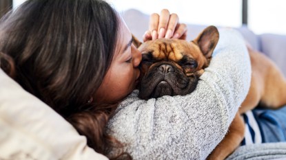 Woman snuggling puppy