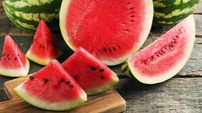 slices of watermelon with seeds on cutting board