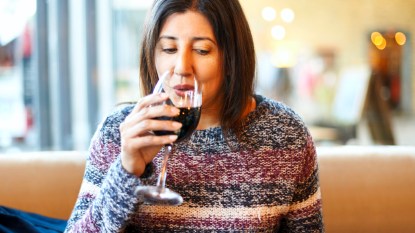 Woman sipping wine