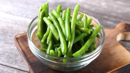 Green beans in a bowl before showing how to blanch them