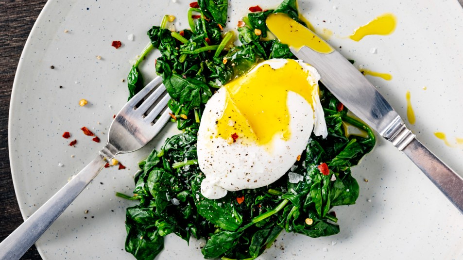 Poached egg on a bed of sautéed greens