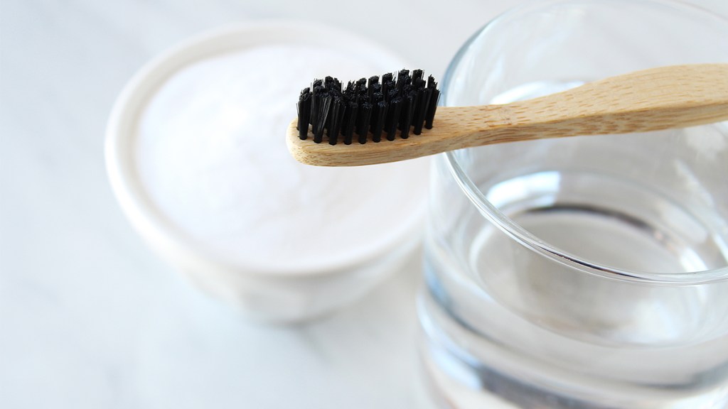 toothbrush with water and a dish of baking soda; baking soda hacks