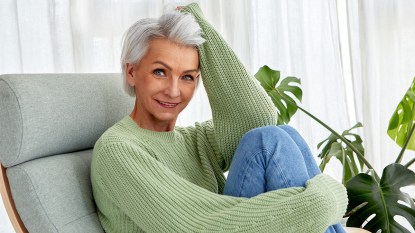 Woman with thick, gray hair who is smiling; she may have used aloe vera for hair loss
