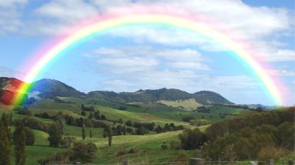 Rainbow over green hills