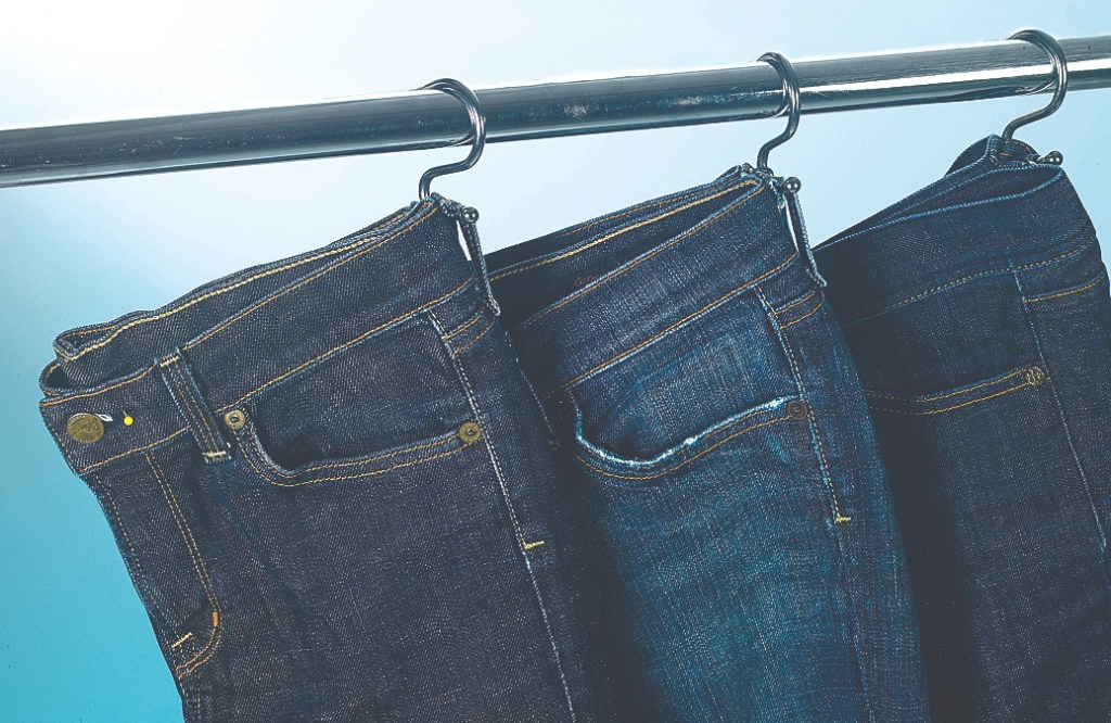 Jeans hung on shower hooks is one of many small closet storage ideas 