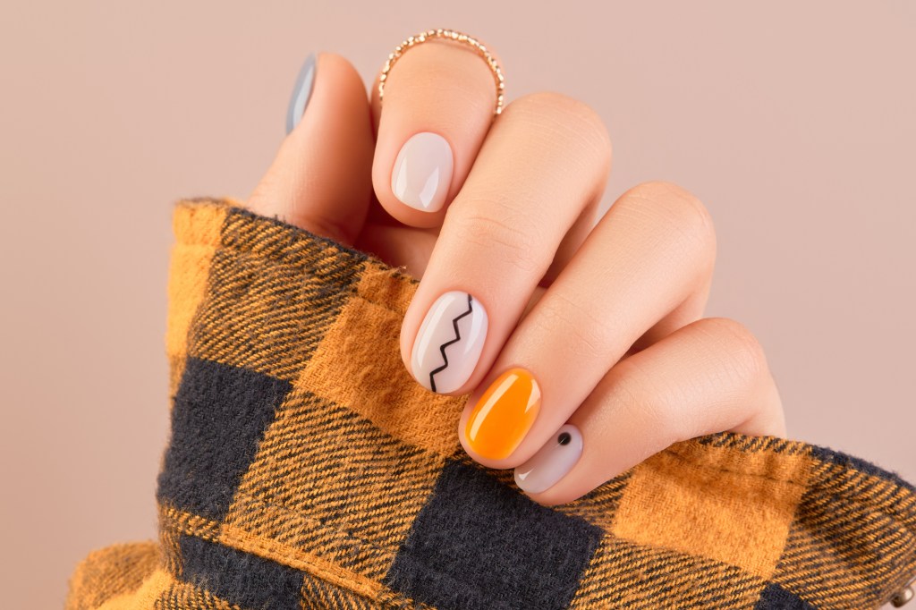 Orange and grey minimalist Halloween nail design