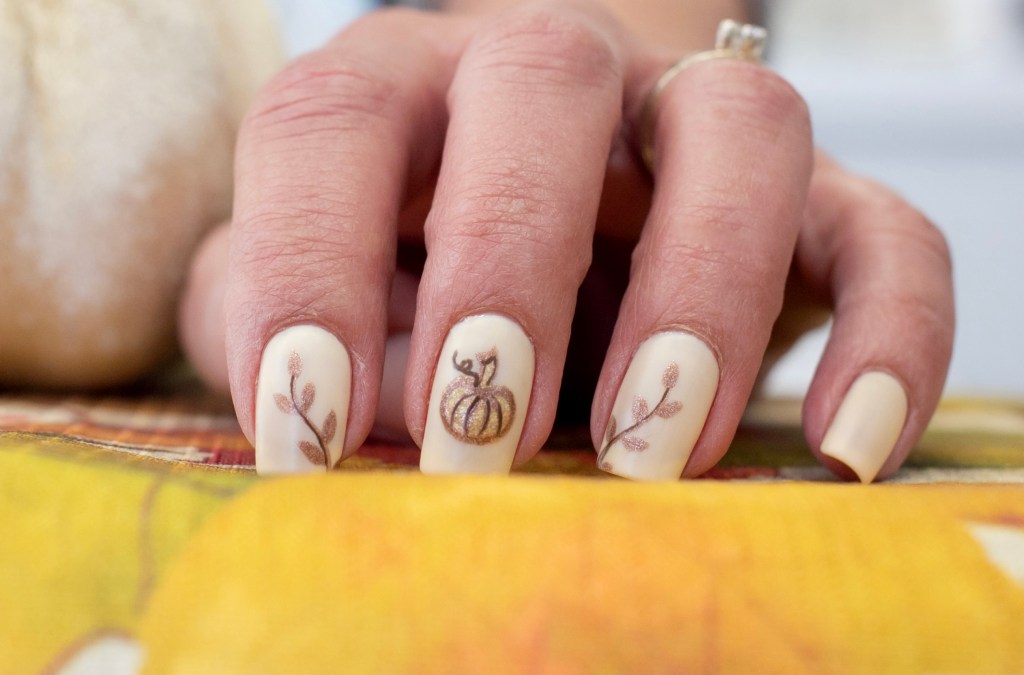Gold pumpkin and leaves design on nails