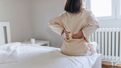 woman who needs pain relief for her sore back in the morning