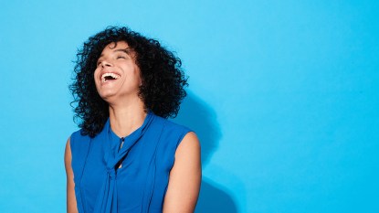 woman smiling laughing blue background