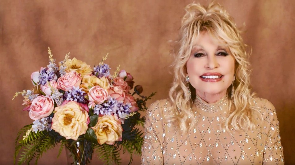 Dolly Parton sitting next to a bouquet of flowers