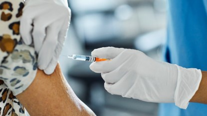 mature woman receiving vaccine in her upper arm