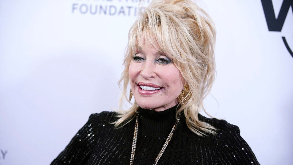 Dolly Parton smiles on a red carpet