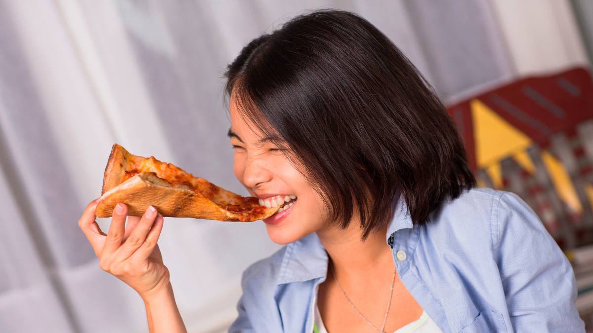 Woman eating pizza