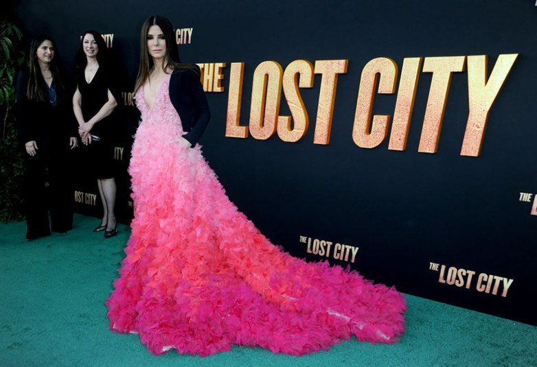 Hollywood actress Sandra Bullock poses for the cameras at The Lost City LA premiere, wearing a hot pink ombre gown.