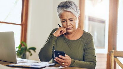 Woman looking at bills and calculating costs