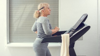mature woman exercising on treadmill