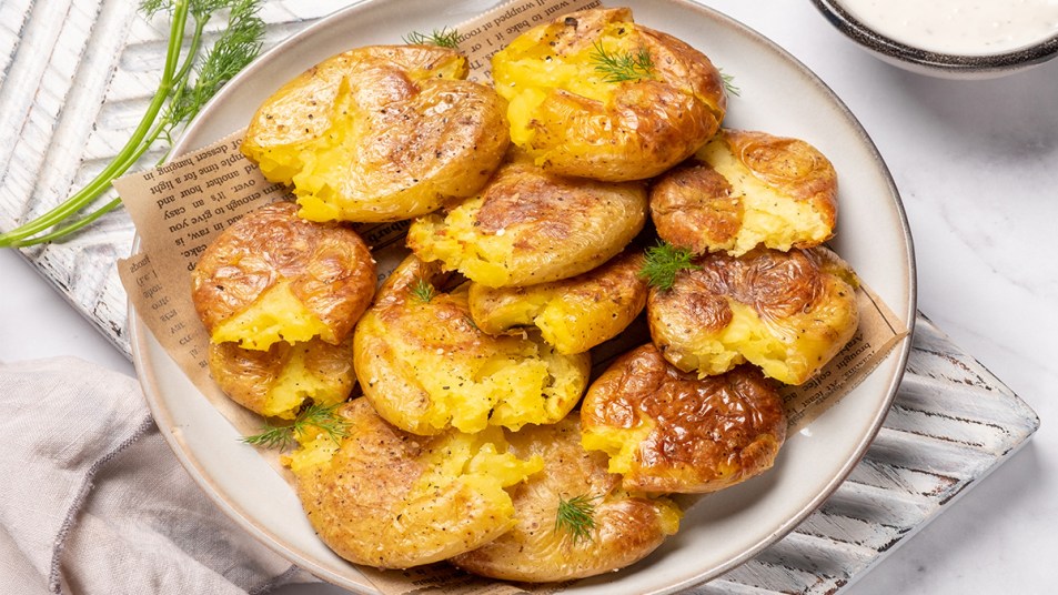A bowl roasted smashed potatoes as part of a guide highlighting celebrity chef Rachael Ray's methods for cooking this dish