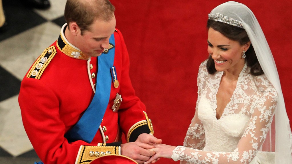 William placing Kate's wedding band on her ring finger