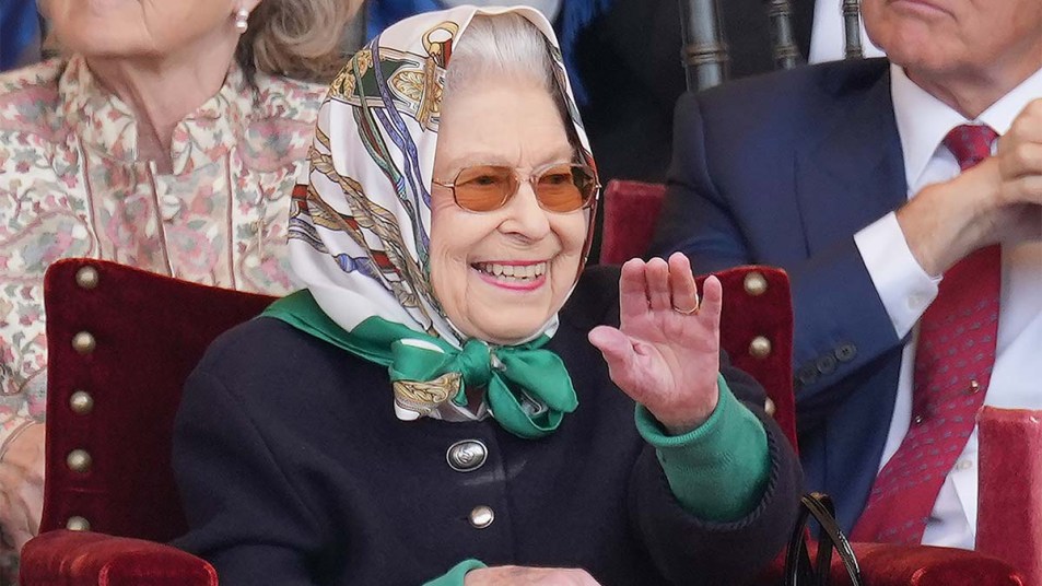 Queen Elizabeth laughing at a joke.
