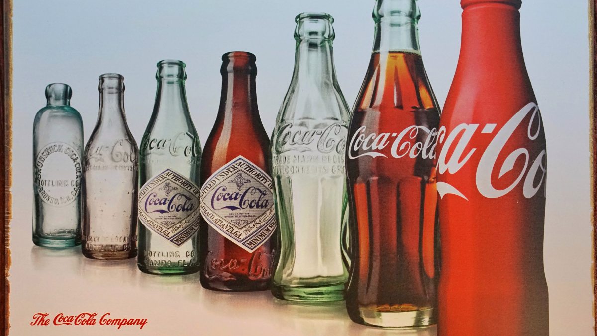 glass coca cola bottles in a row