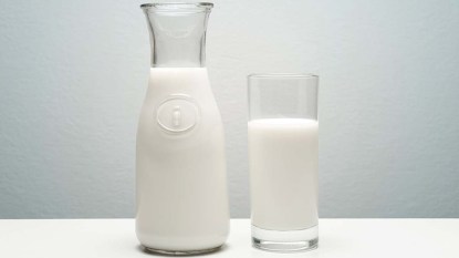 A glass and carafe full of milk