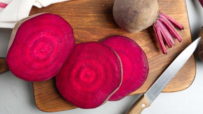 Fresh beets on a wooden cutting board