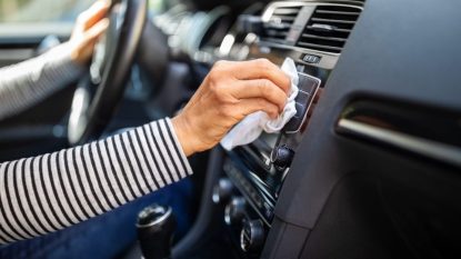 Woman's hands cleaning car
