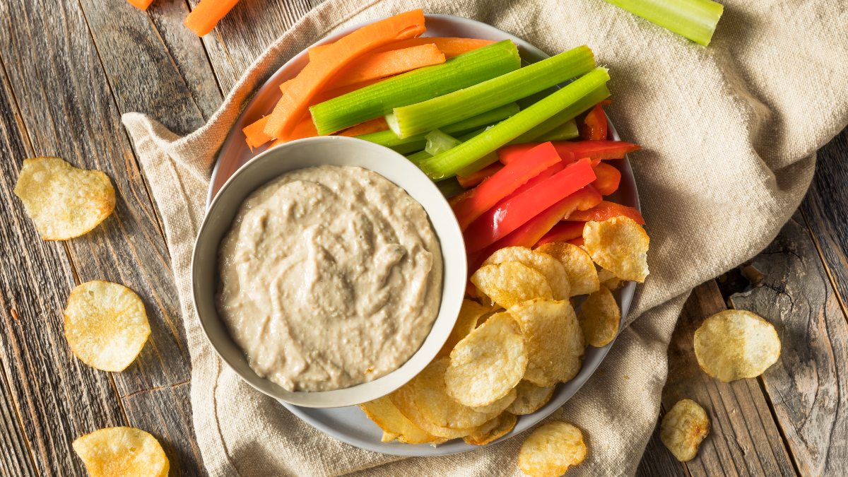 caramelized onion dip with vegetable dippers and chips