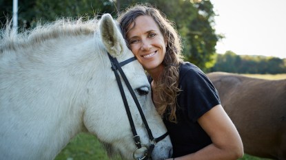 smiling woman with a horse