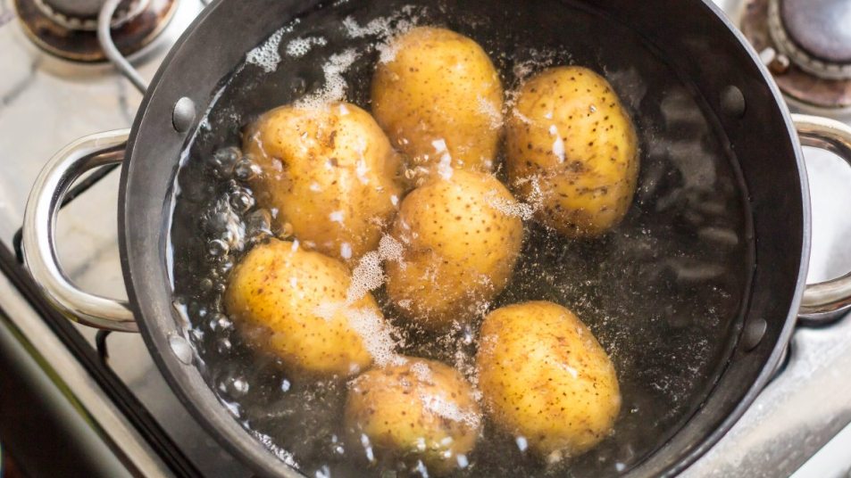 golden potatoes boiling in a pan, creating potato water