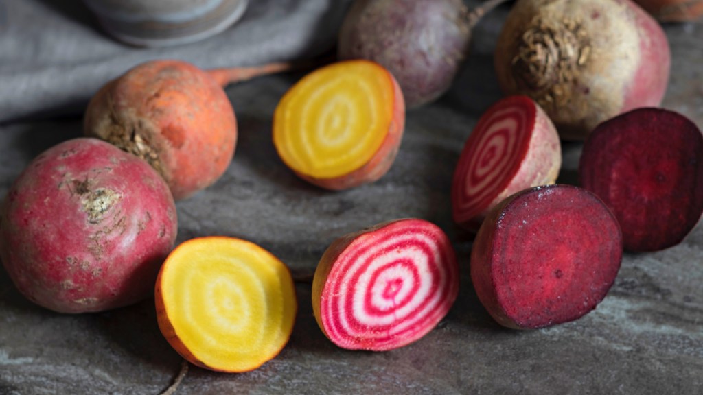 Red, purple and golden beetroot vegetables on a table, which have health benefits for females