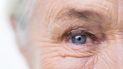 close up on blue eye of senior woman with white hair