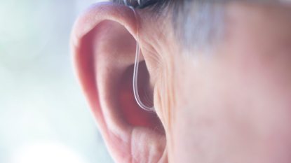 hearing aid in a mature woman's ear