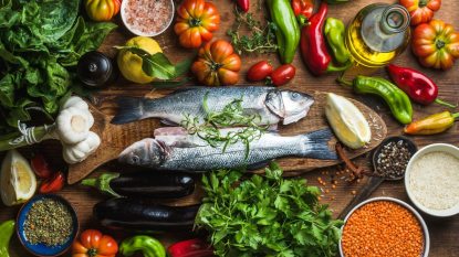 spread of foods included in the Mediterranean diet, fish, whole grains, fruits, vegetables