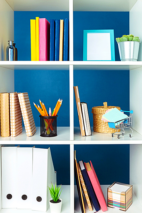Stacks of supplies and paperwork in the office and bookshelves