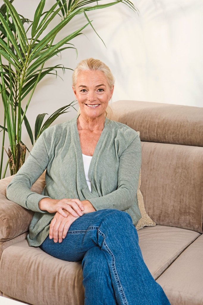 Mature woman sitting on sofa
