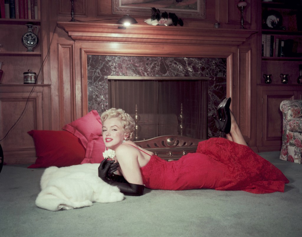 Marilyn Monroe in front of fireplace