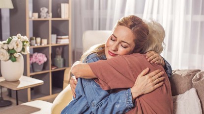 Two-women-embracing-each-other-in-a-living-room