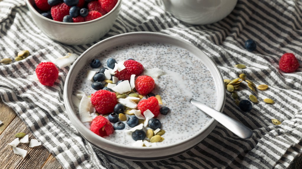 Bowl of chia seeds soaked in milk for weight loss, topped with berries