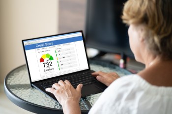 Woman Checking Credit Score Ranking On Laptop Computer