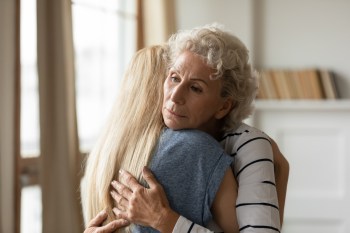 Young empathic woman embracing soothing comforting frustrated older mature mother