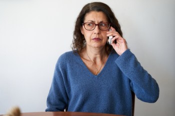 Mature woman receiving a fraud phone call