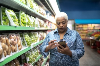 Woman in grocery store on phone
