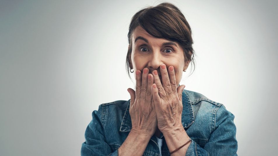 woman covering mouth in embarrassment