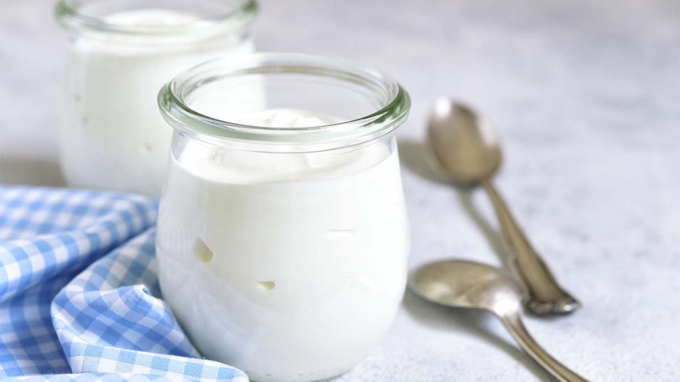 Two portions of fresh natural homemade organic yogurt in a glass jar