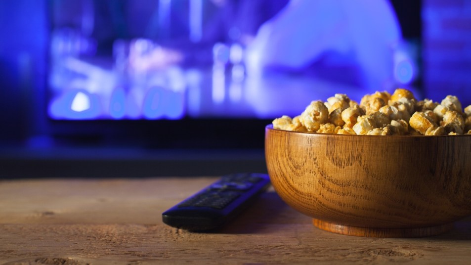 bowl of popcorn by a TV, eating late at night