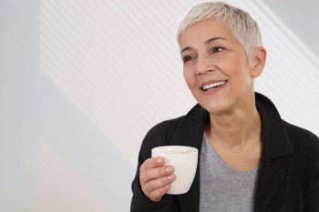 Happy Smiling Mature Woman drinking coffee