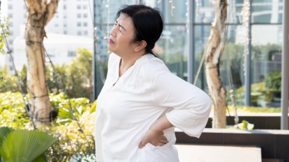 asian senior woman suffering from waist and back pain, concept of back muscle stiffness, herniated disc, spine problem, gout, rheumatoid, osteoporosis